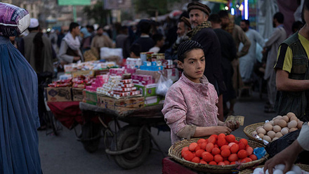 boy-standing-at-dyed-eggs-market-stall-in-downtown-Kabul-women-and-men-passing-by-1168x440.jpg