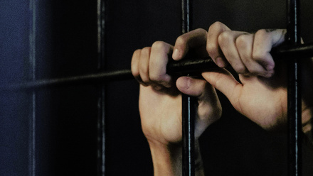 hands-of-jailed-person-1168x440px.jpg 1